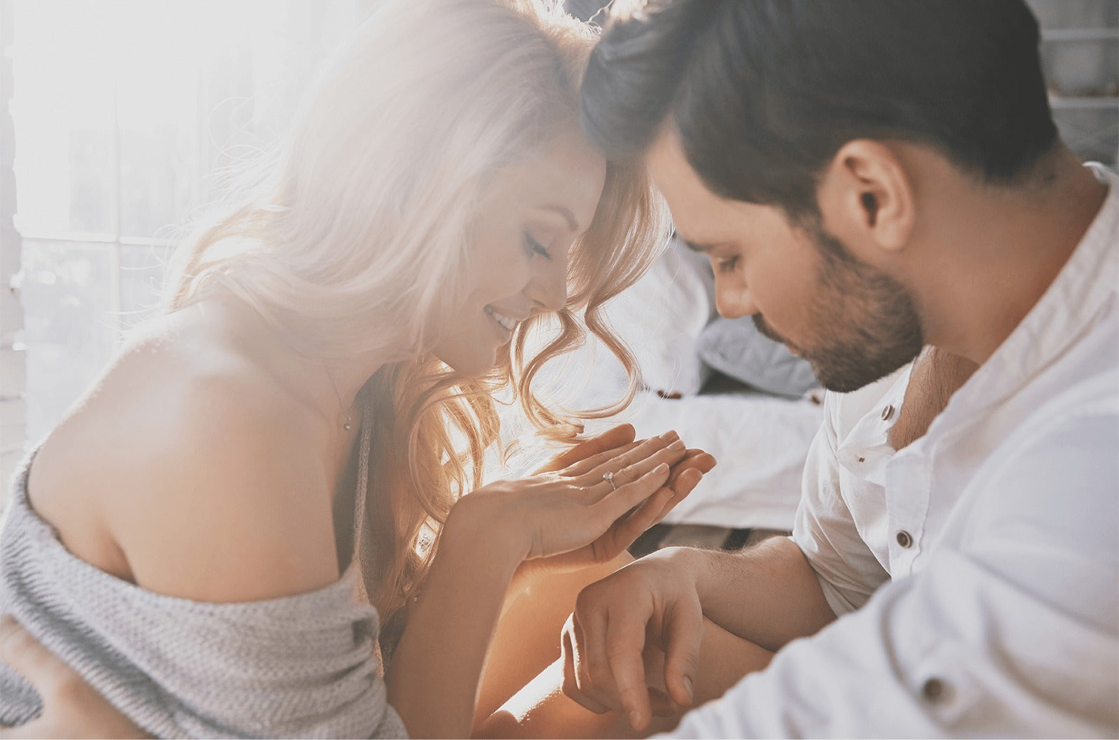 man and woman looking at the engagement ring