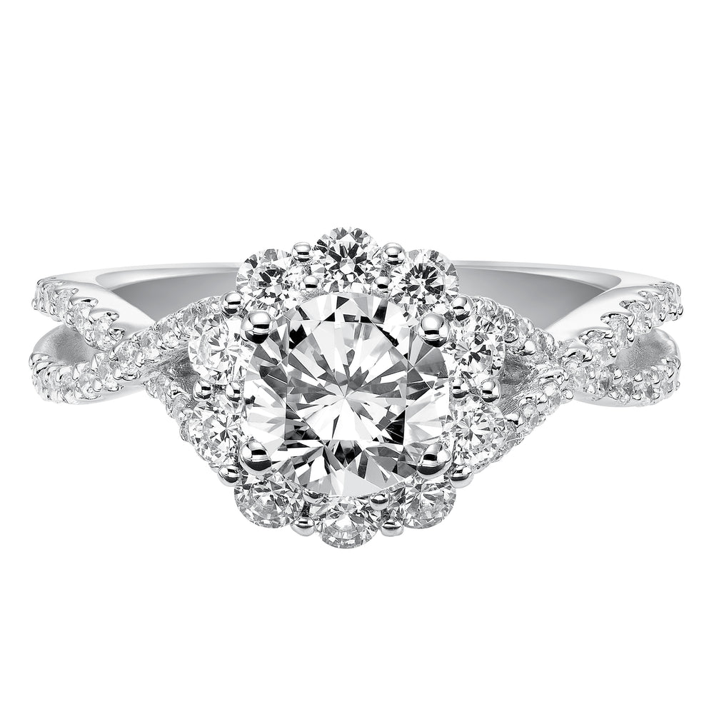 Awe-inspiring sparkle illuminates from this engagement ring featuring a shared prong set diamond halo and elegant twisted diamond band for grand effect..  Center Stone is not included.