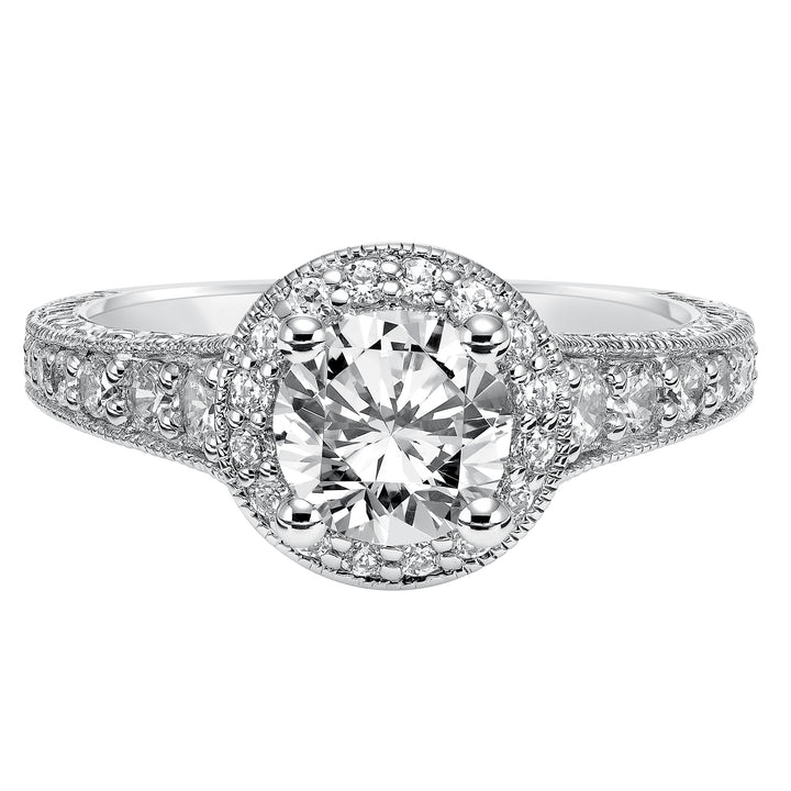 This show-stopping engagement ring is sure to impress with its diamond prong set halo and band with milgrain and engraving.  Center Stone is not included.