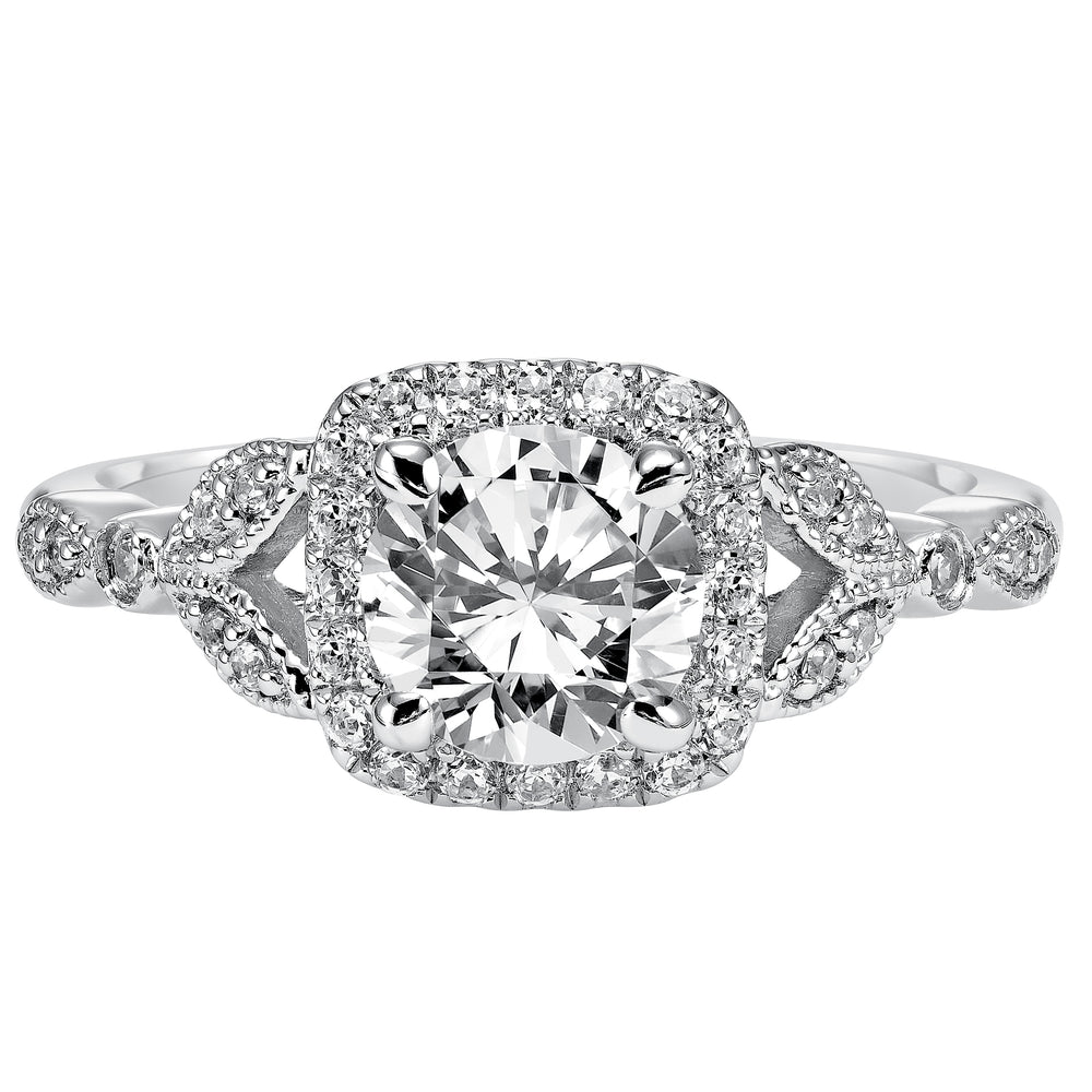 This whimsically styled engagement ring sparkles with its filigree and diamond halo and diamond prong set floral-inspired band.  Center Stone is not included.