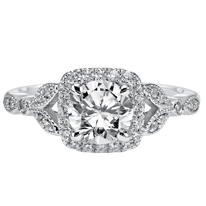 This whimsically styled engagement ring sparkles with its filigree and diamond halo and diamond prong set floral-inspired band.  Center Stone is not included.