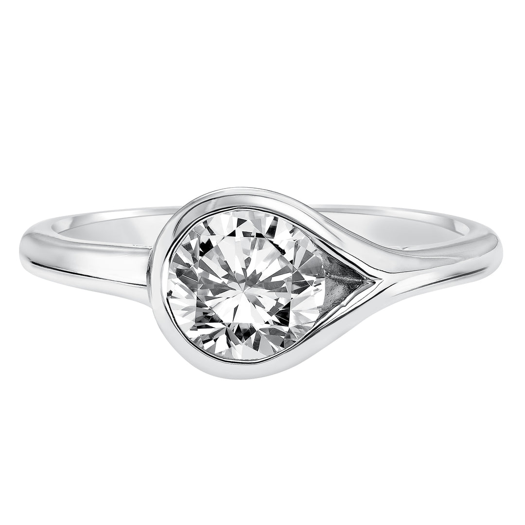 Chic and modern, this engagement ring is set beautifully in a high polished bezel set and bypass designed band