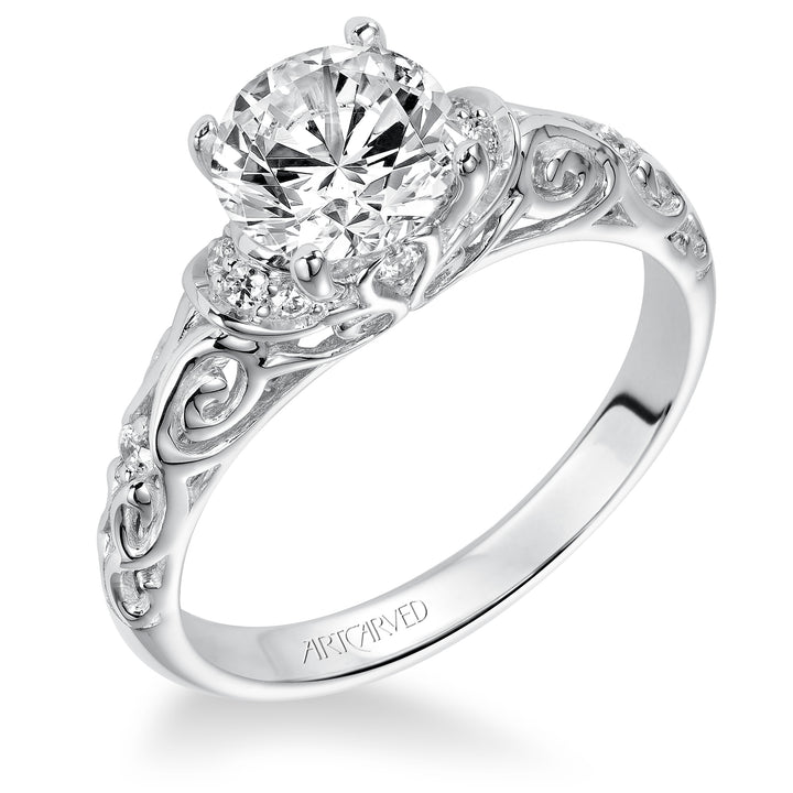 Diamond engagement ring with round center stone and carved diamond enhanced band