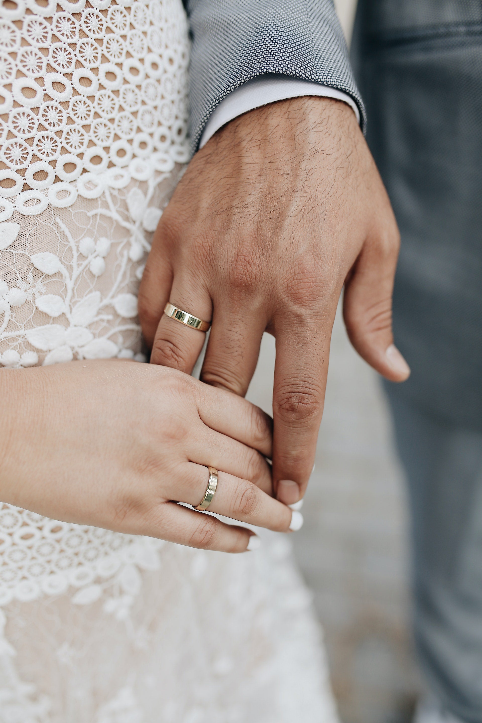 bride and groom hands with wedding rings